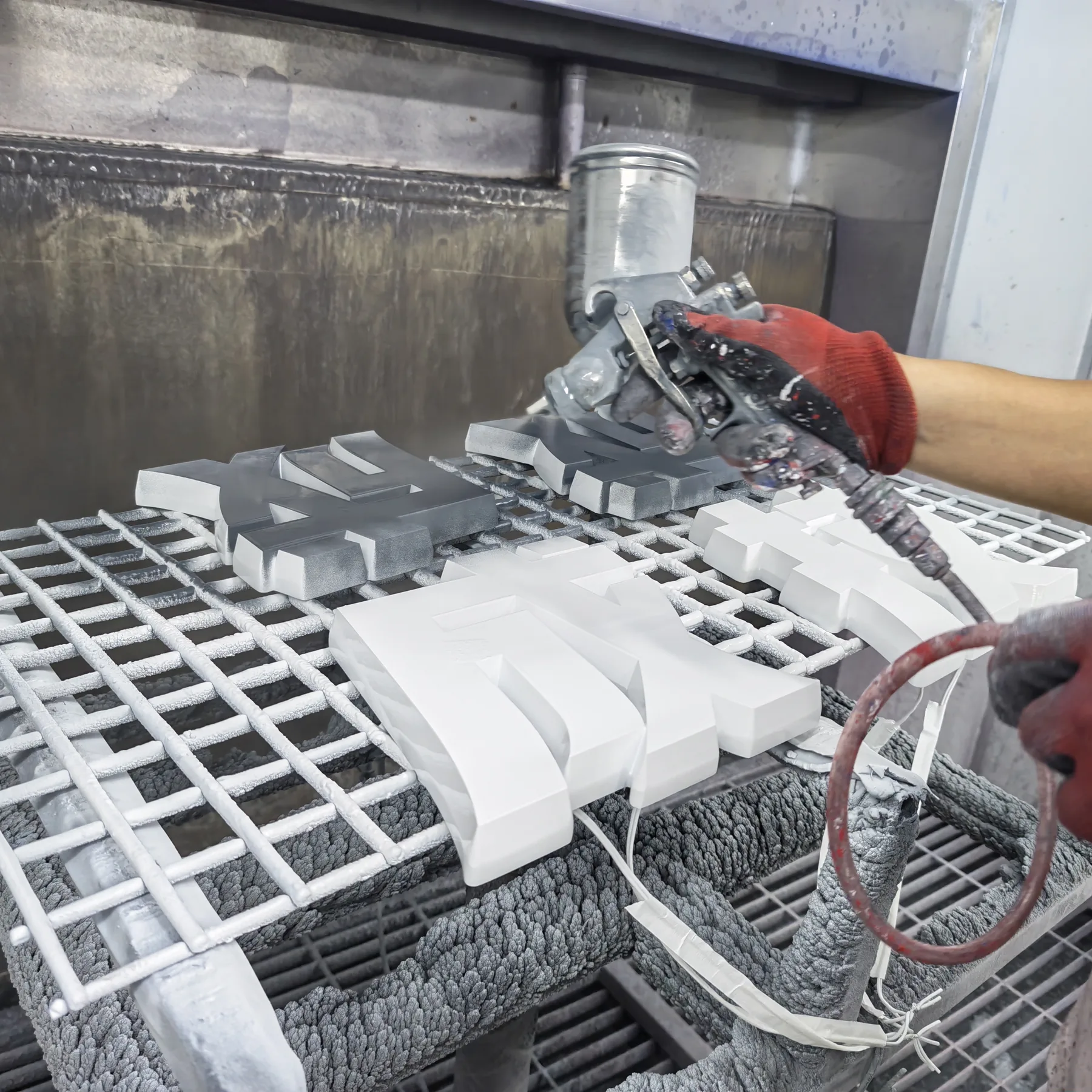 Spray finishing custom dimensional sign letters during production